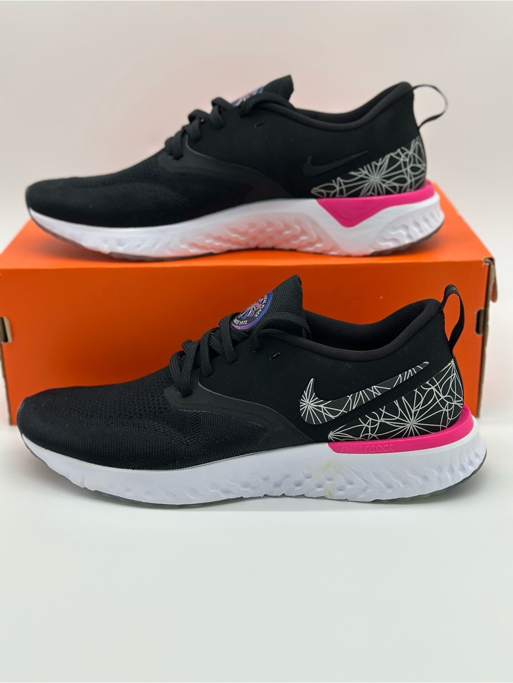 Nike Black Sneakers with White Geometric Swoosh and Pink Heel Detail